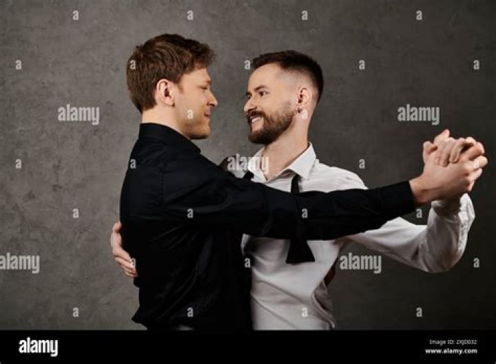 Gay Couple Dancing And Kissing At Party Stock Photo Download Image